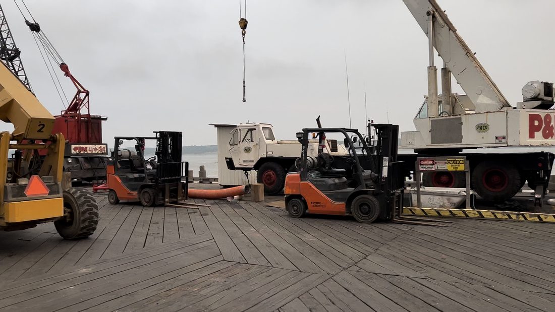 Cranes and forklifts on a dock in Alaska