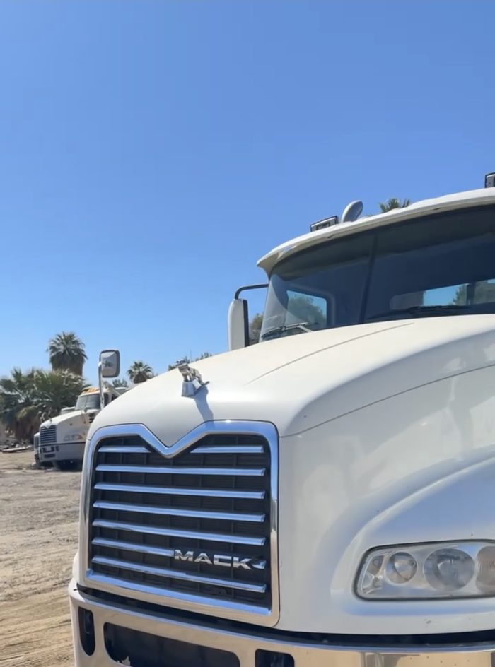 White Mack truck on a dirt yard