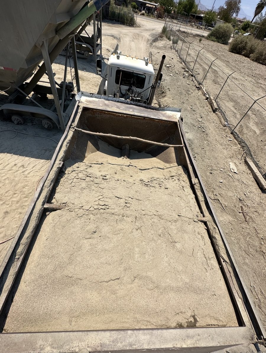 Loaded truck bed seen from above at a yard